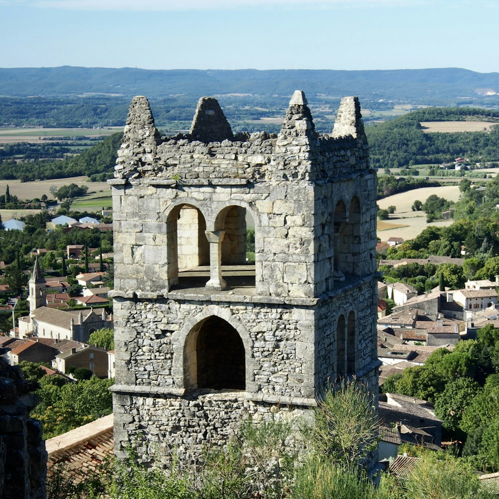 a stone tower with a bell on top of it