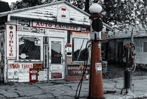 A vintage gas station with rustic signage and warm lighting.