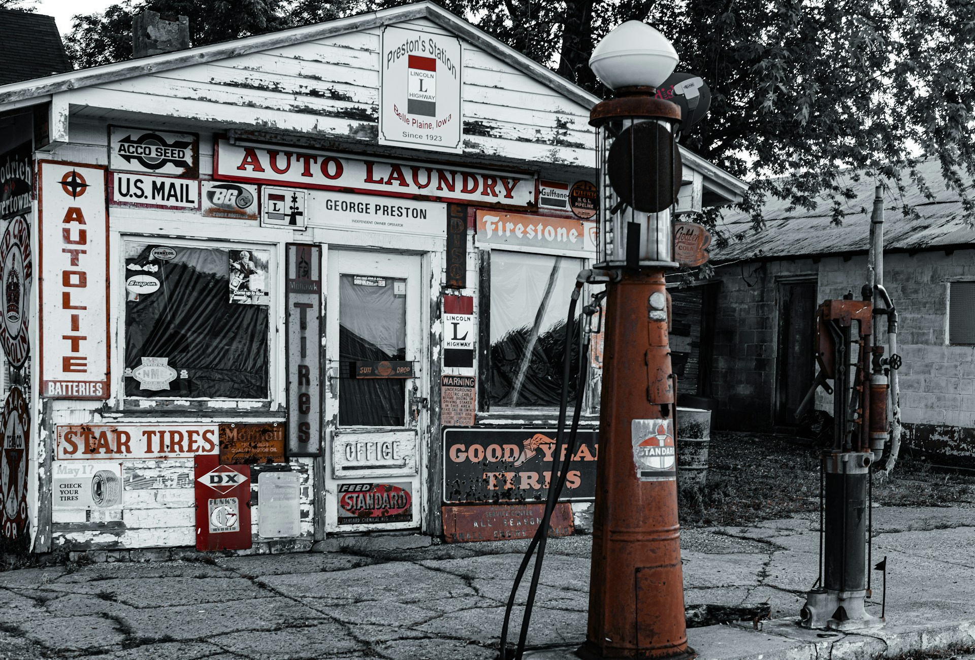 a black and white photo of a gas station