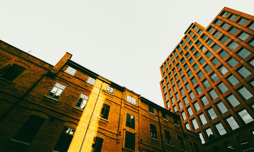 a tall brick building next to a tall brick building