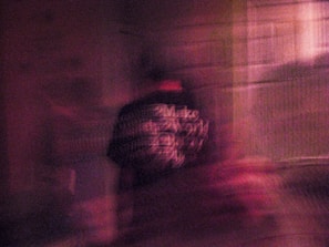 A blurred photo of hospital records with sensitive patient information redacted.