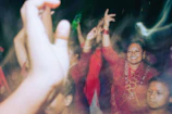 A joyful group of people dancing in traditional attire.