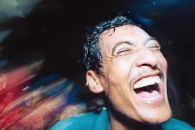 A dynamic caricature of a sports fan cheering wildly, with expressive eyes and bold lines.