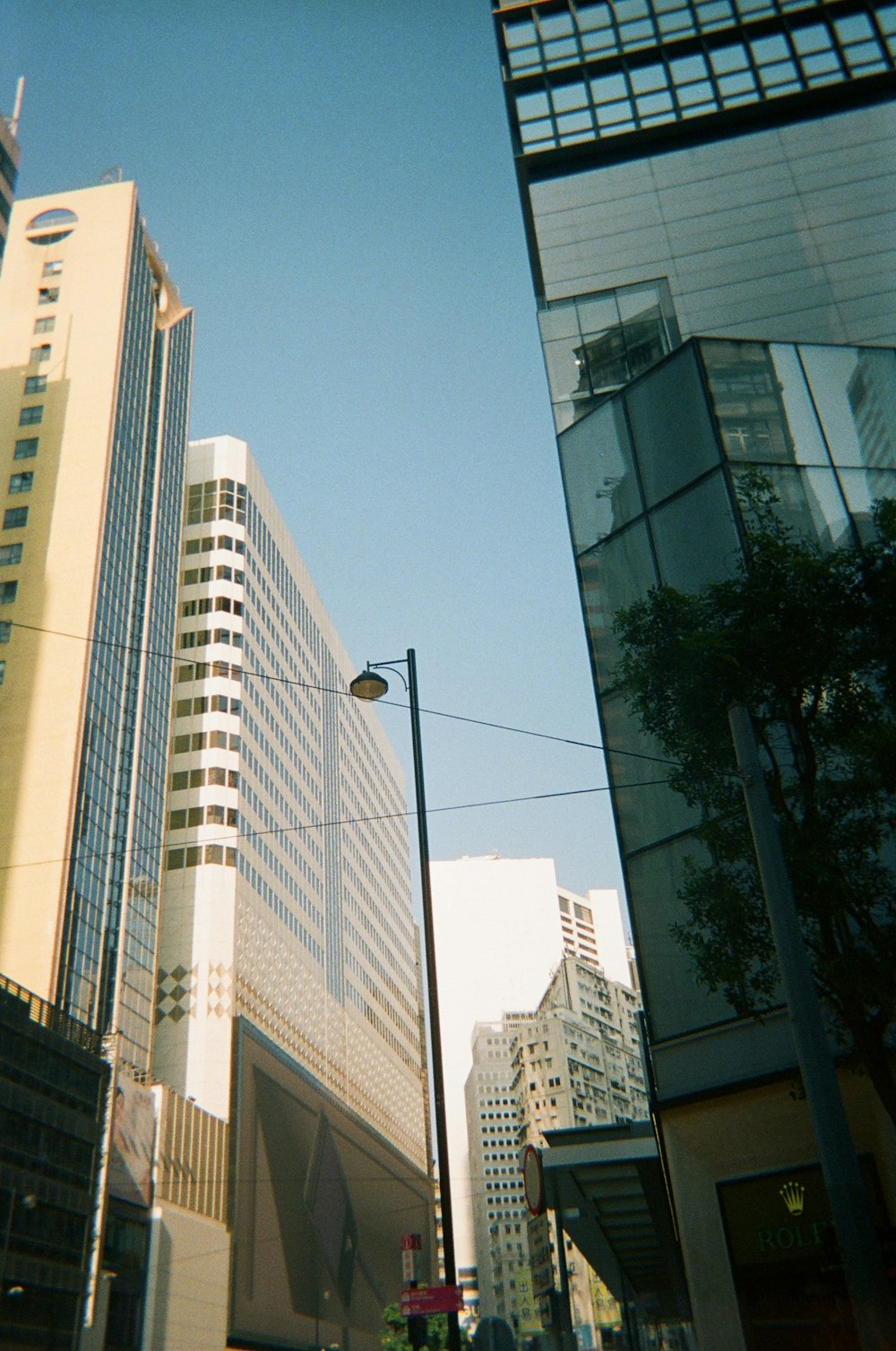 a city street with tall buildings in the background