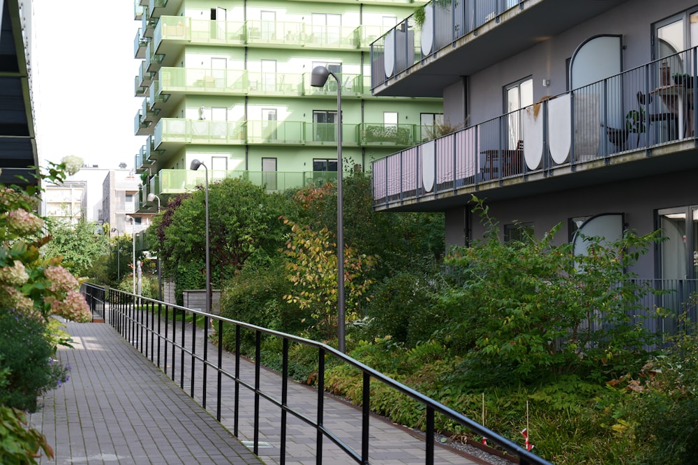 a walkway in front of a building with balconies