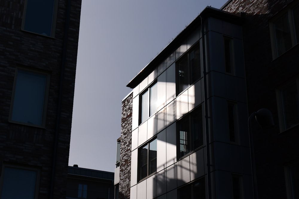 a tall building with windows and a sky background