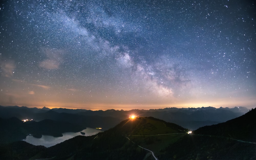 a view of the night sky over a mountain range