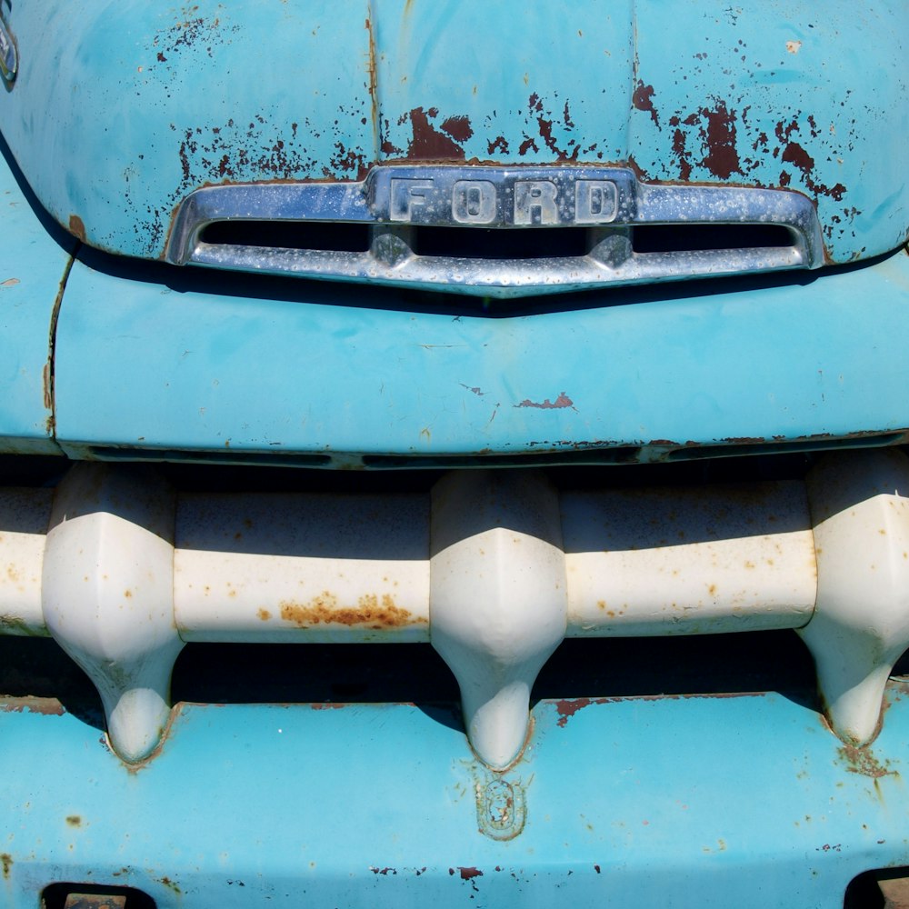 a close up of the front of a blue car