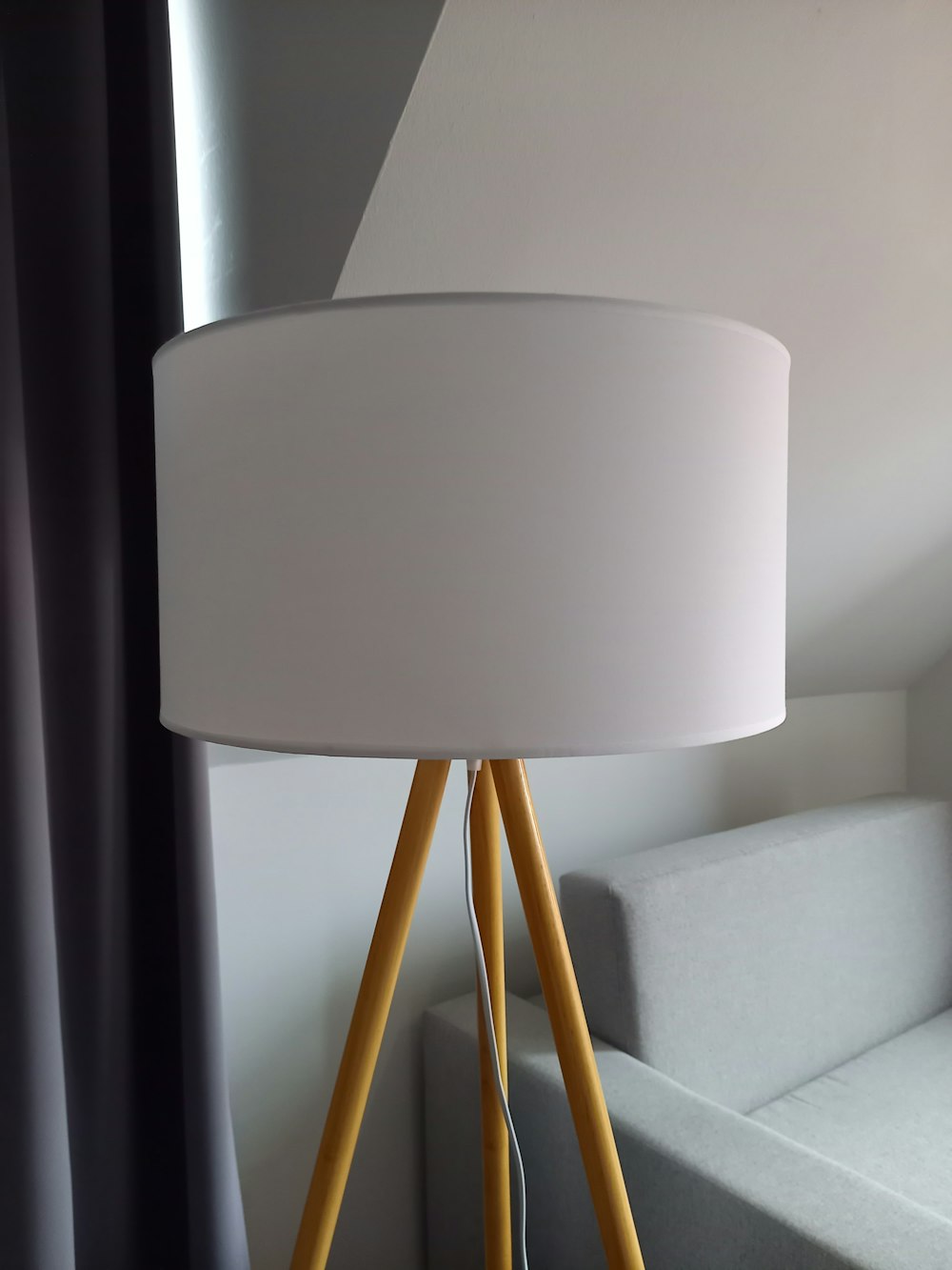 a white lamp sitting on top of a wooden table