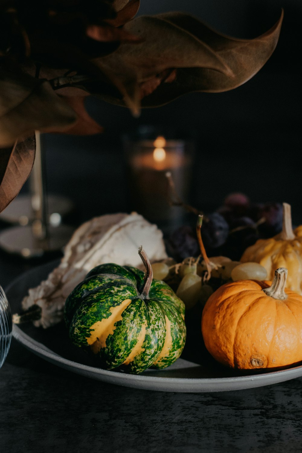 a plate of pumpkins and gourds on a table