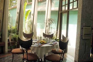 Sunlit dining area with a wooden table set for a family meal