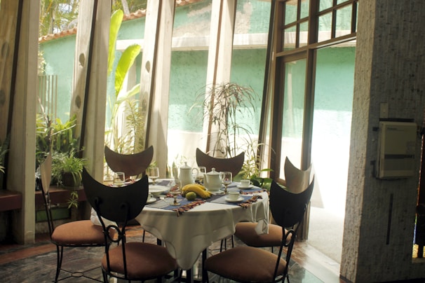 Sunlit dining area with a wooden table set for a family meal