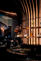 Sophisticated bar display showcasing a range of premium Asian-inspired liquors in ambient lighting.