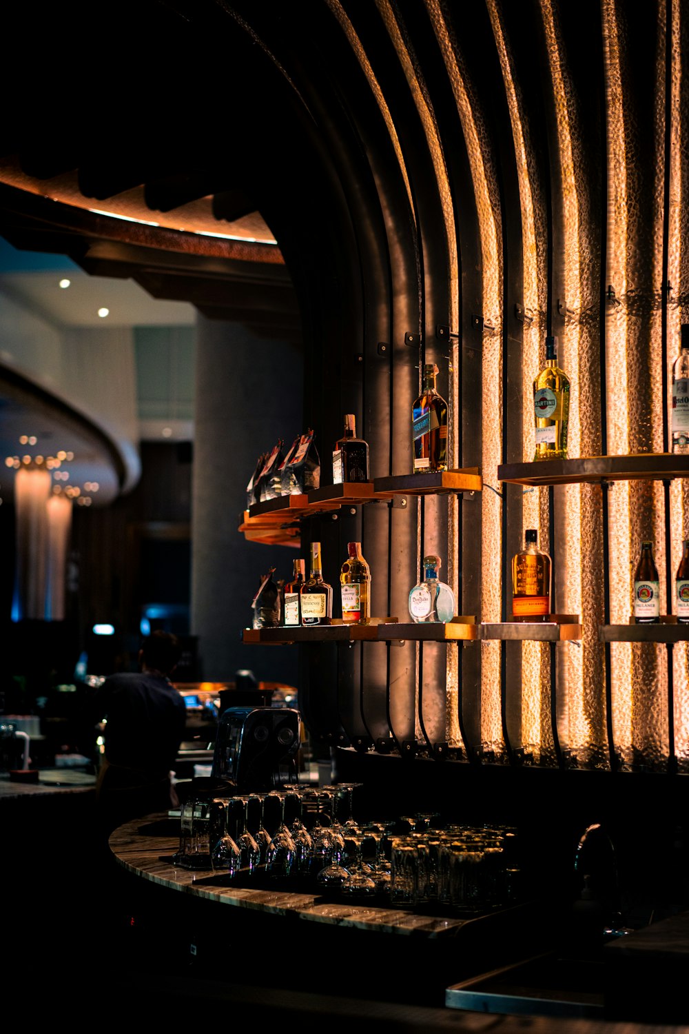 a bar with shelves filled with bottles of liquor