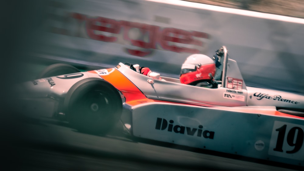 a man driving a race car on a track