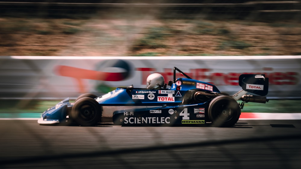 a man driving a race car on a track