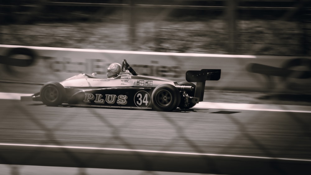 a man driving a race car on a track