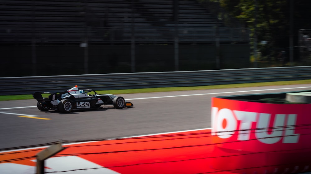 a man driving a race car on a race track