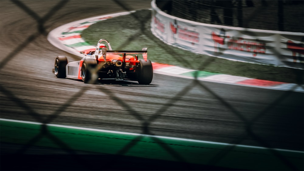 a man driving a race car on a track