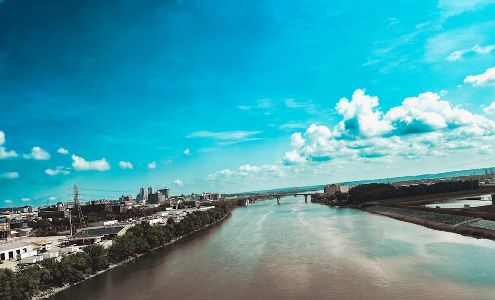 a river running through a city under a blue sky