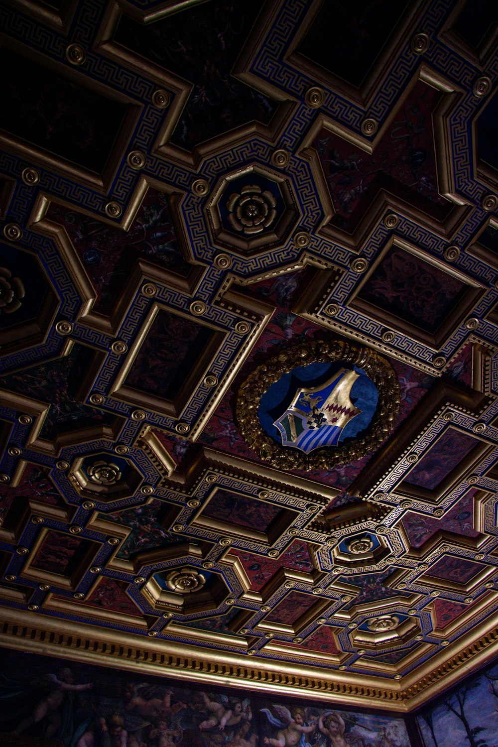 a decorative ceiling with a clock on it