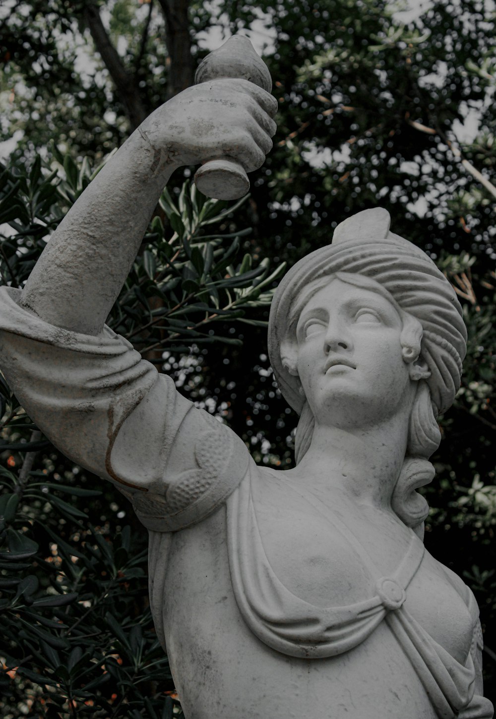 a statue of a woman holding a baseball bat