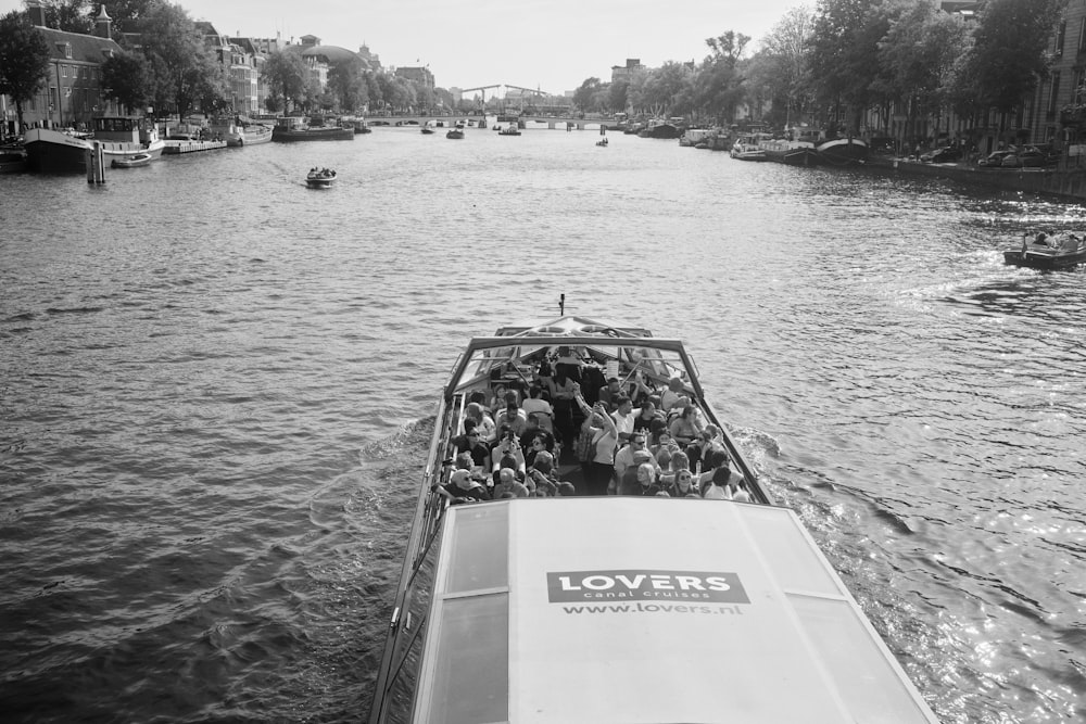 a boat full of people traveling down a river