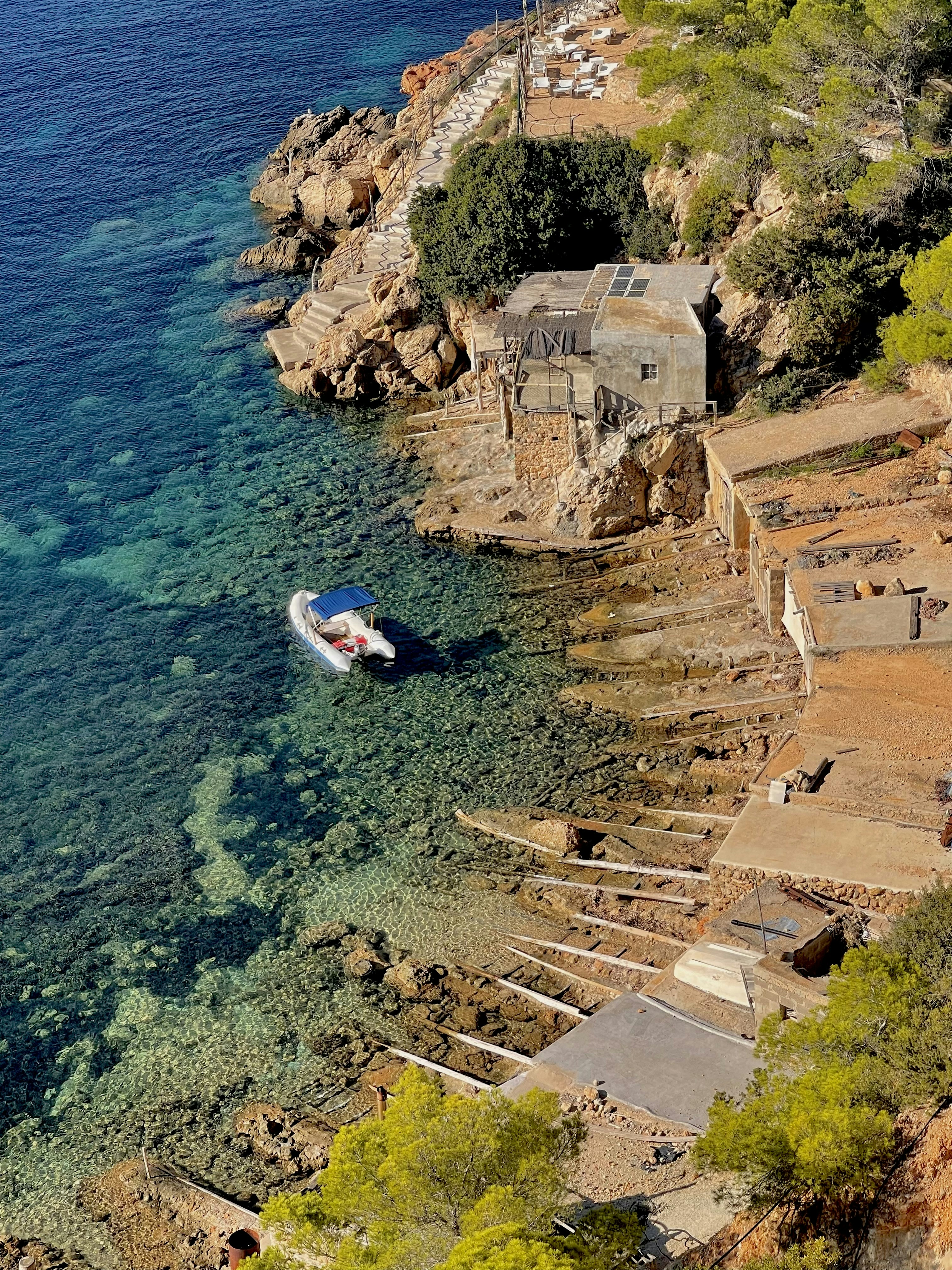 an aerial view of a boat in a body of water