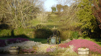 A solar powered pump in a garden setting.