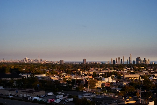 A panoramic view of the Hyderabad city skyline with a Vamshi Warehousing distribution center in the foreground.
