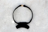 A stylish black leather choker with subtle silver details on a white background.