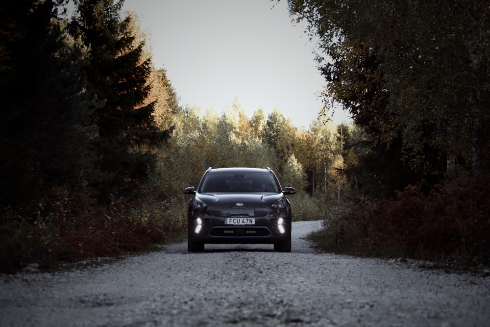 a car is driving down a gravel road