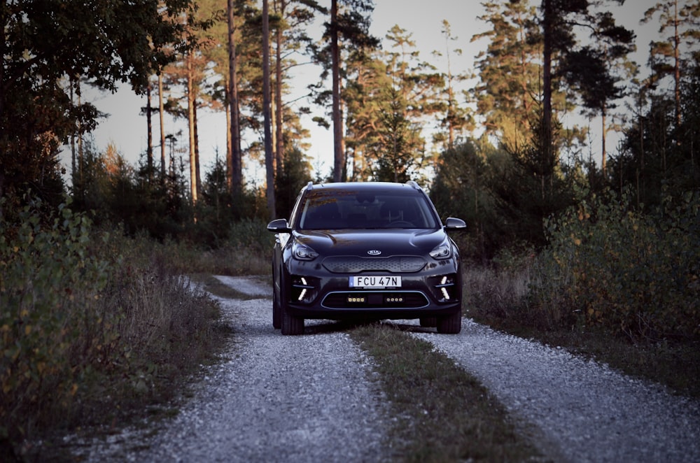 a car is driving down a gravel road