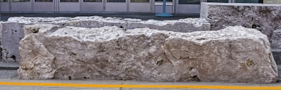 Delivery professional carefully handling natural stone slabs at a modern apartment entrance.