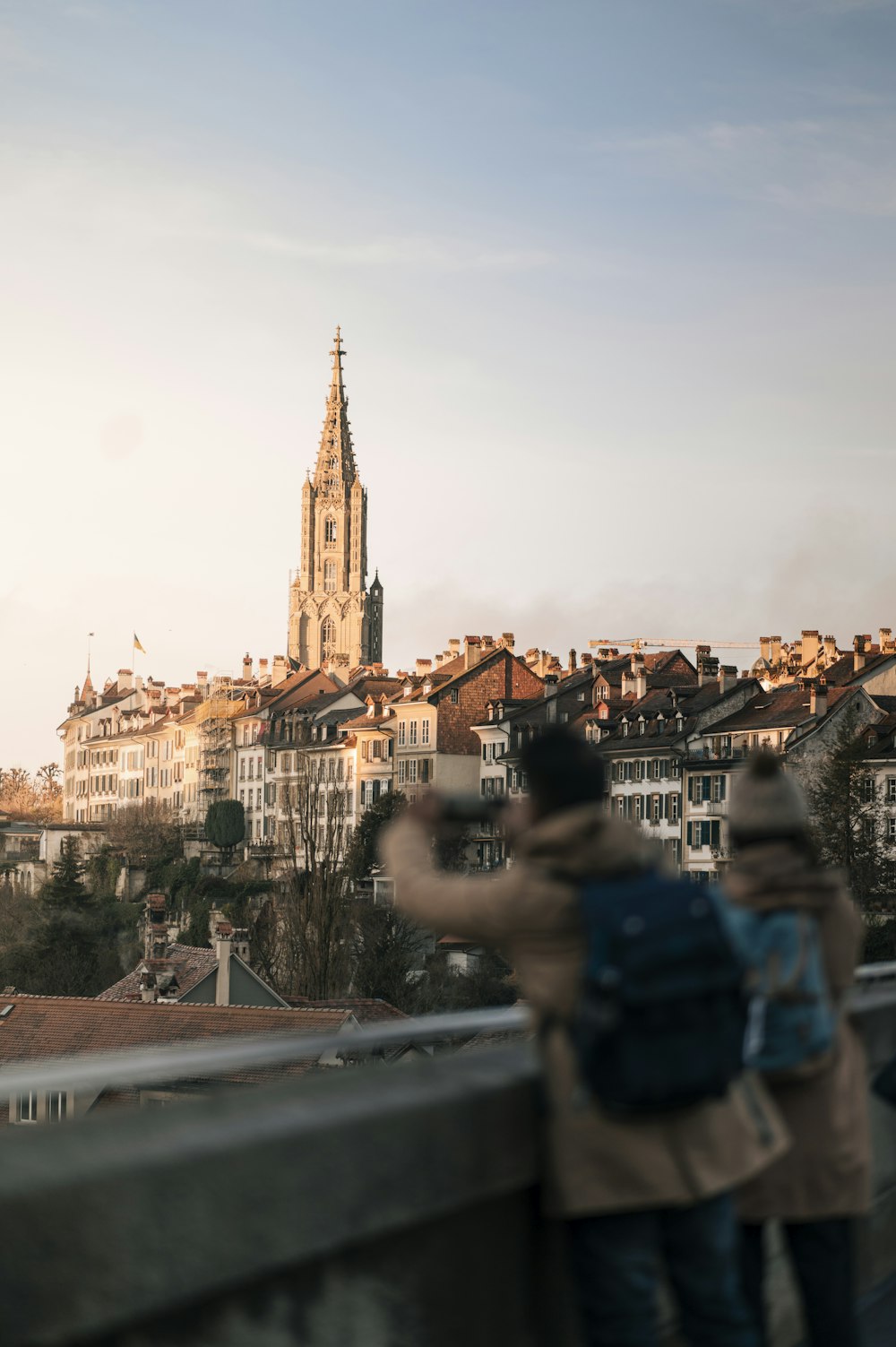 a couple of people that are standing on a bridge