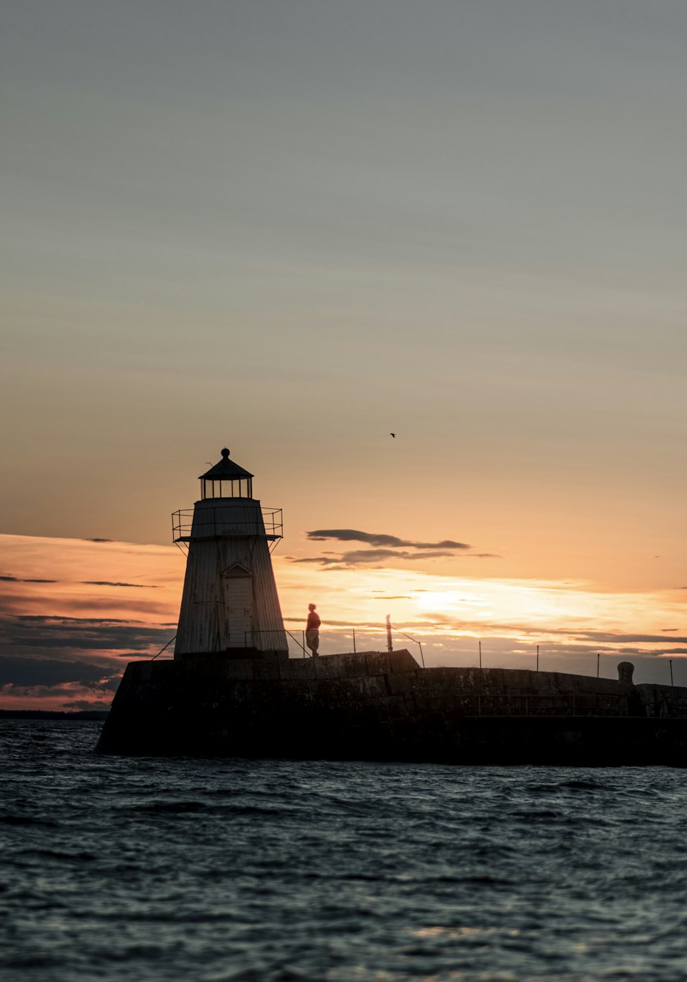 a light house sitting on top of a body of water