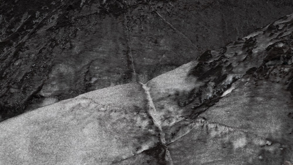 a black and white photo of a rock face