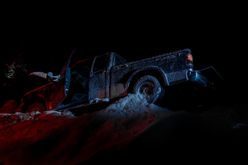 a truck is parked in the snow at night