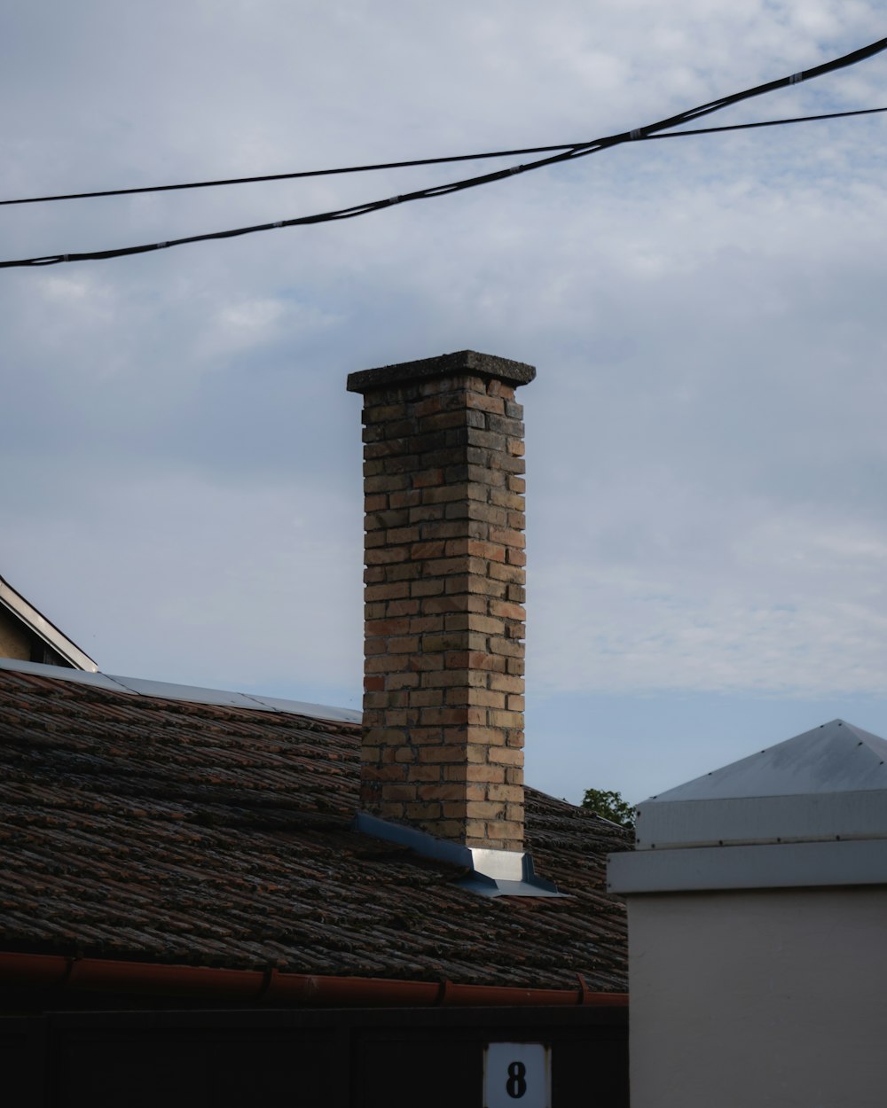 a tall brick chimney on top of a building