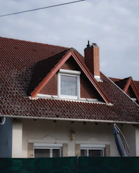 a house with a brown roof and a white window