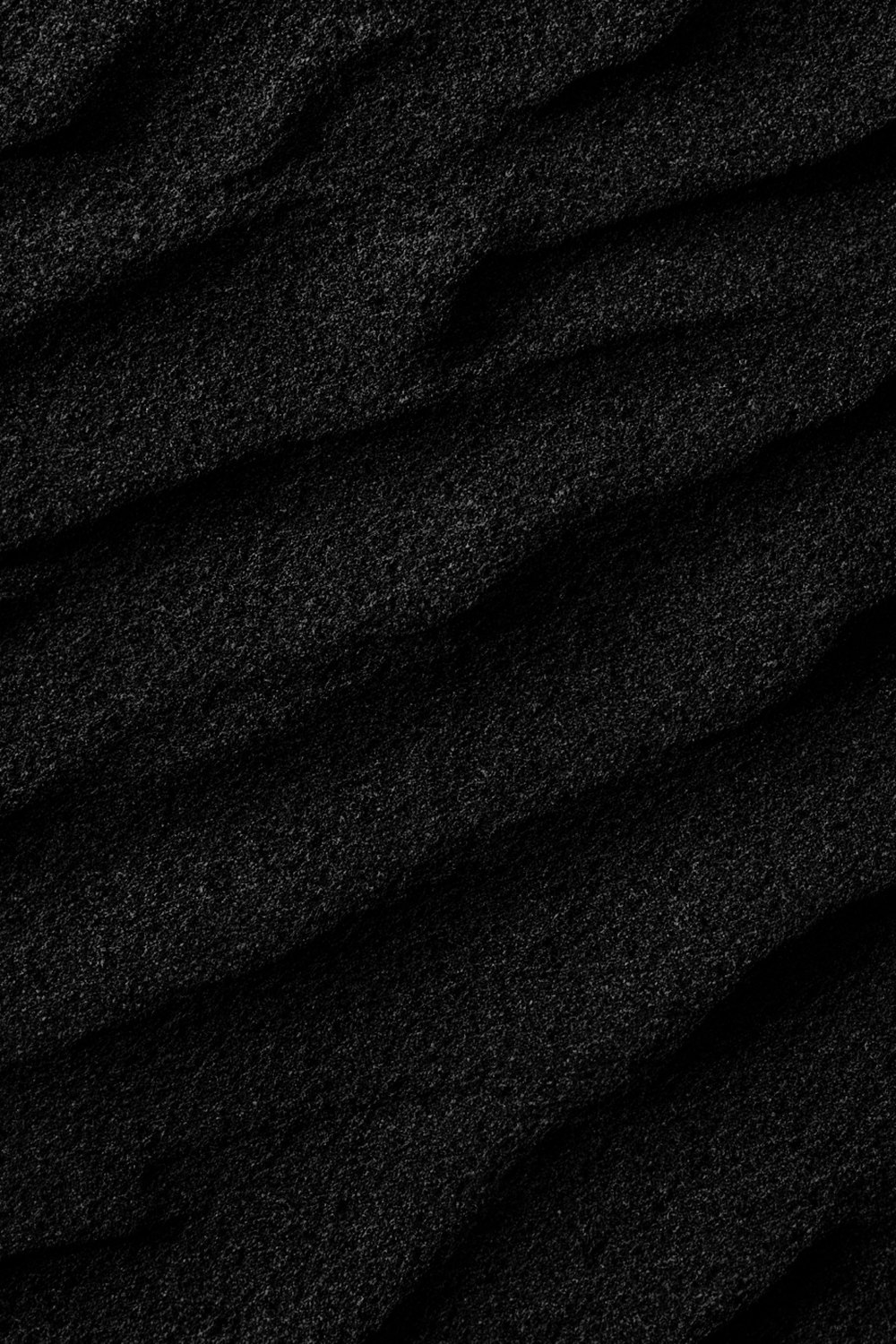 a close up of a black sand texture