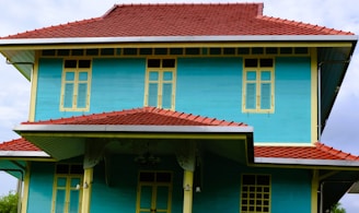 Traditional Bahir Dar style house featuring colorful painted walls and a tiled roof.