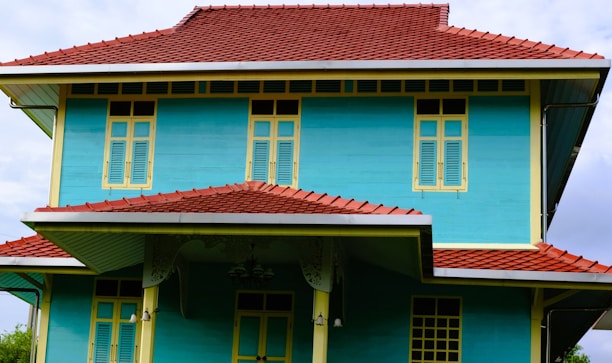 Traditional Bahir Dar style house featuring colorful painted walls and a tiled roof.