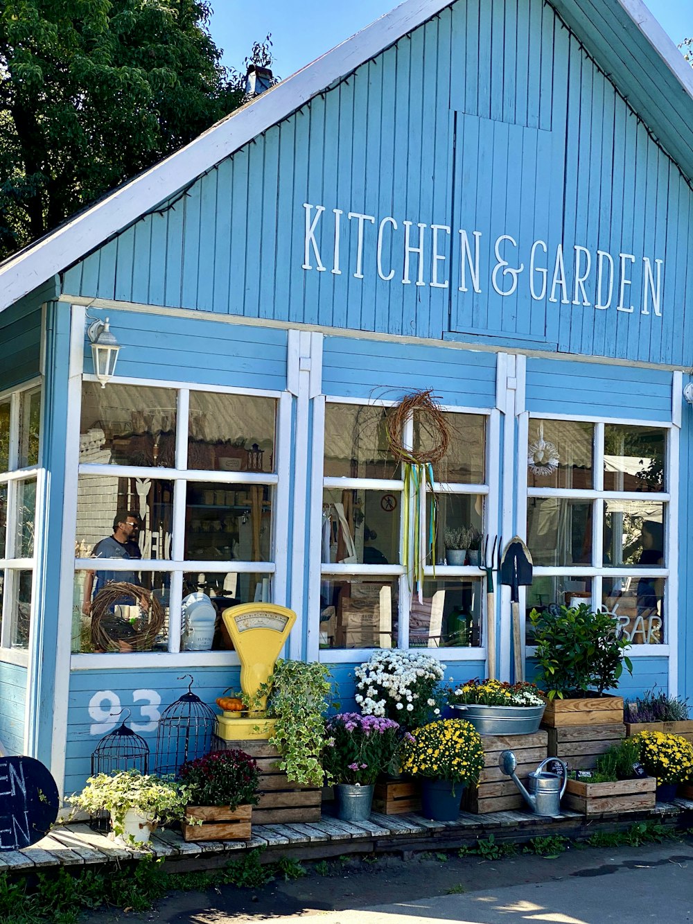 a blue building with a sign that says kitchen and garden