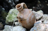 Close-up illustration of water flowing from a jug symbolizing the life-giving qualities of Aquarius.