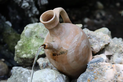 Close-up illustration of water flowing from a jug symbolizing the life-giving qualities of Aquarius.