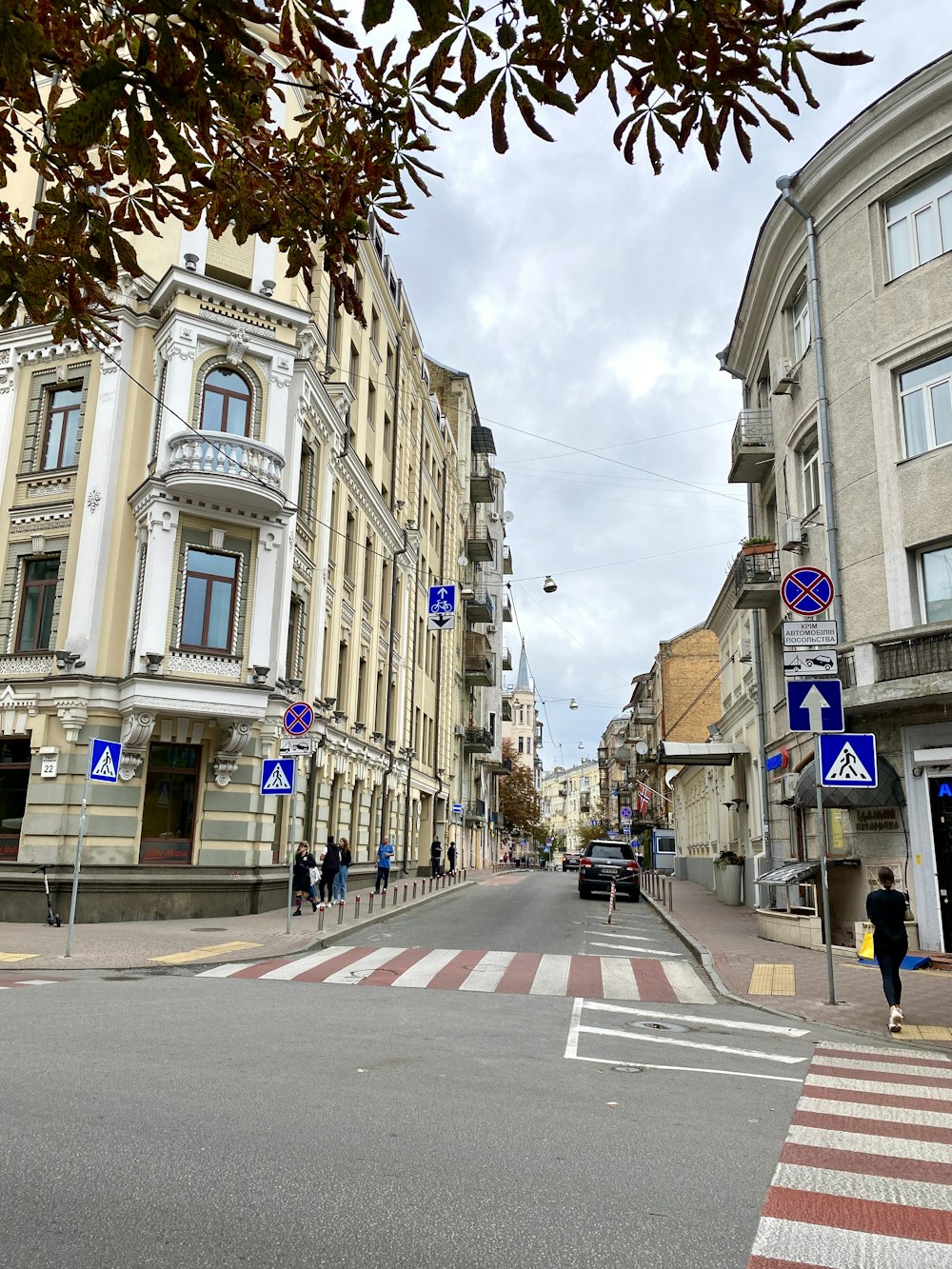 a city street with buildings and a crosswalk
