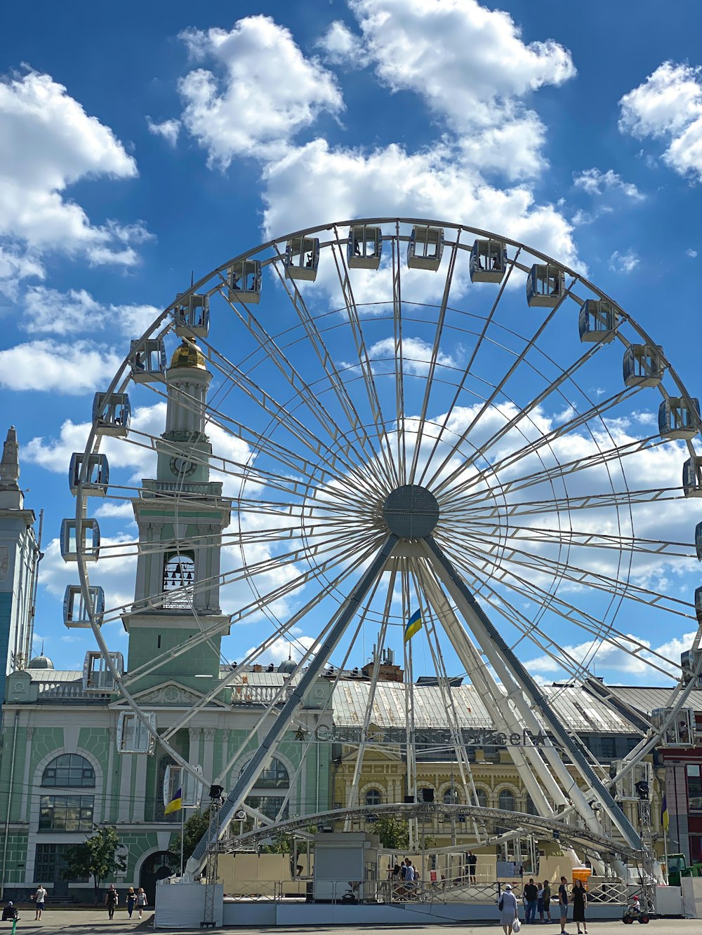 a large ferris wheel sitting in front of a building