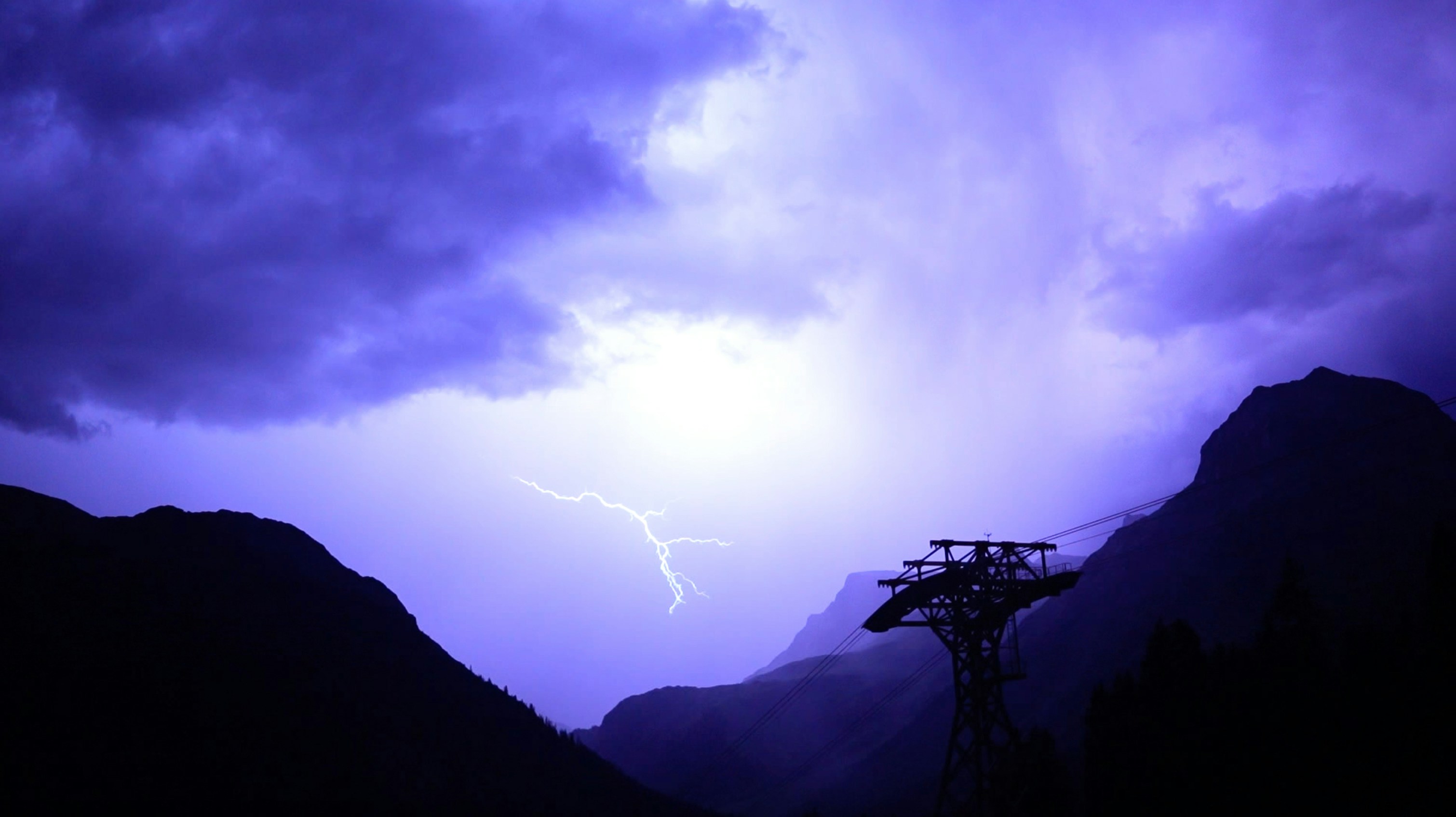 a purple sky with a lightning bolt in the distance
