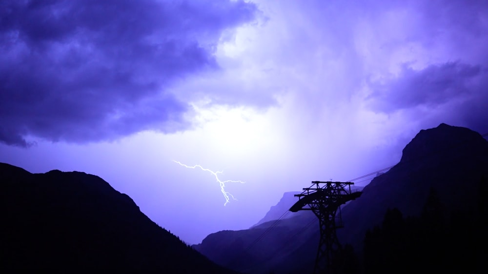 a purple sky with a lightning bolt in the distance